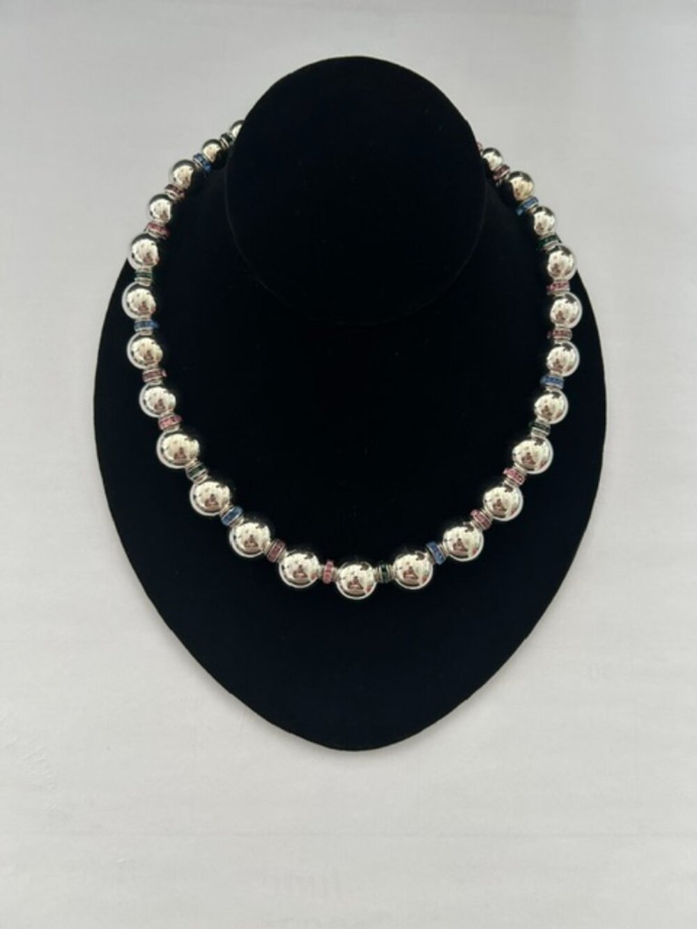 Elegant silver-tone beaded necklace with multicolor spacer accents